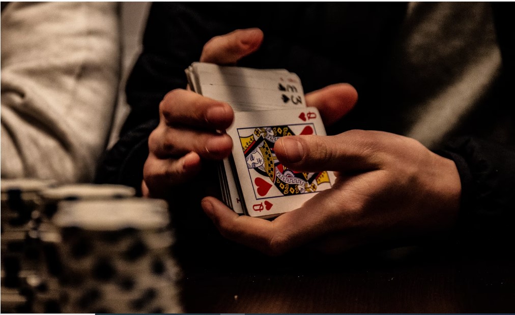  person holding deck of cards