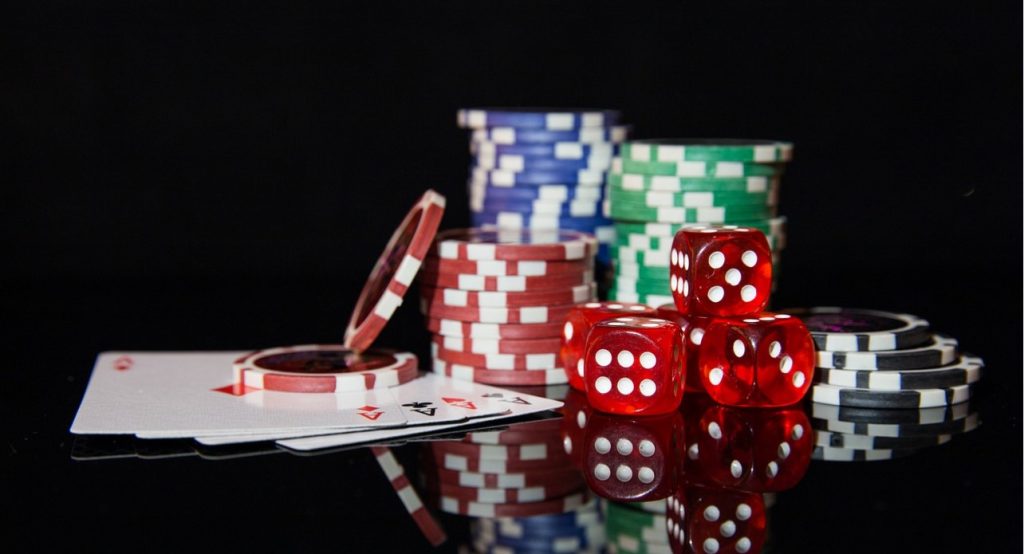 casino coins and some cards on table