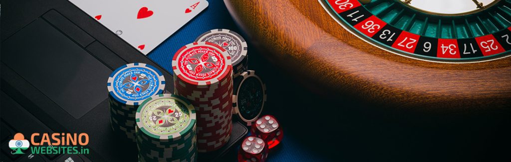 Red green and Purple casino chips with dice with ace card